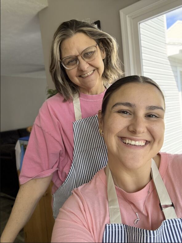 Mary and Julia smiling in aprons.