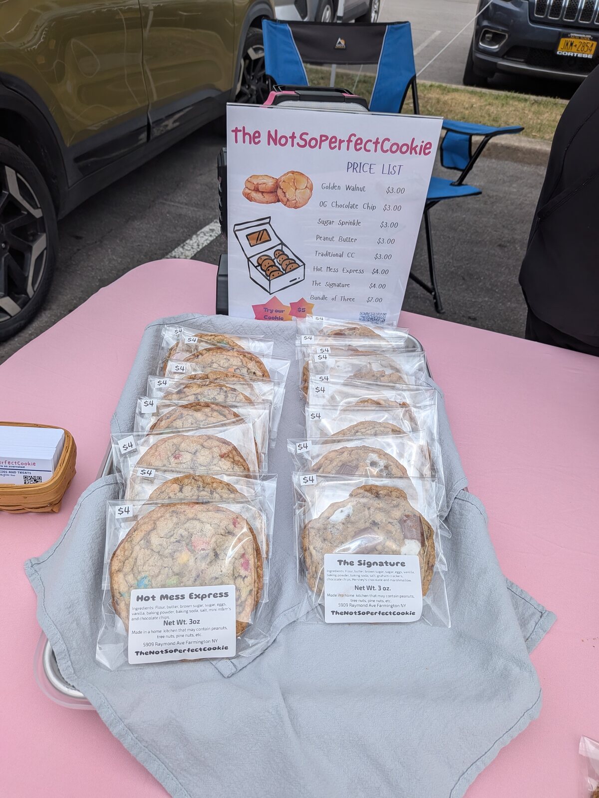 Hot Mess Express and Signature cookies displayed beside the market price list