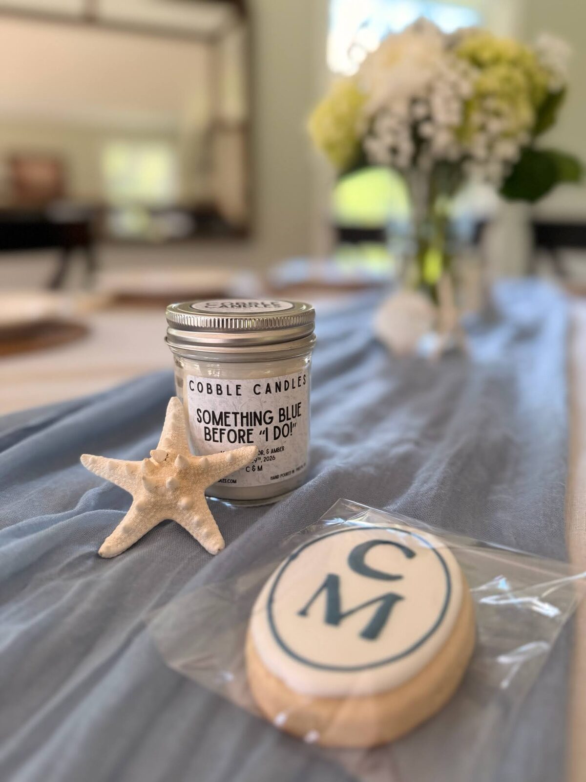 A custom frosted cookie displayed at a wedding table.